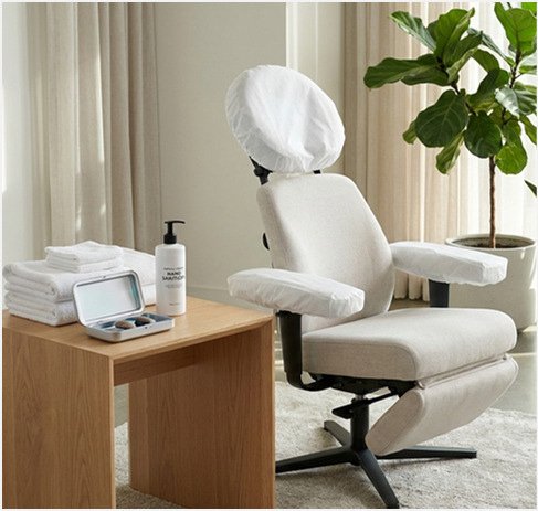 Clean massage chair with fresh towels and sanitiser